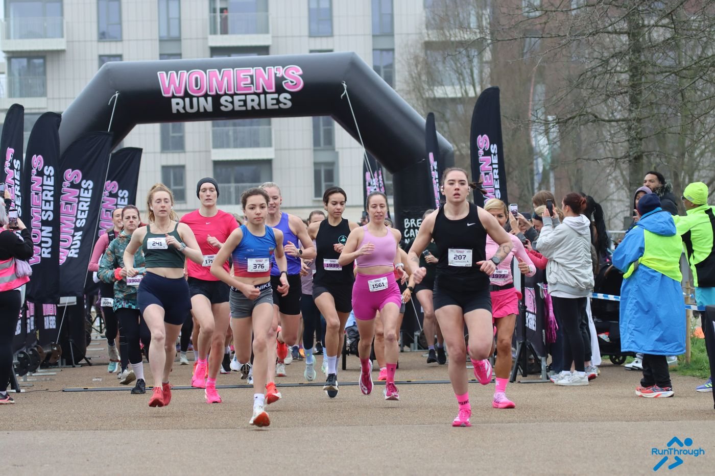 Runners starting under the Women's Run Series arch at Queen Elizabeth Olympic Park